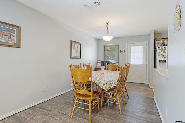 dining space featuring dark wood-type flooring