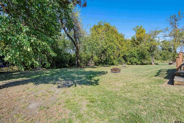 view of yard with a fire pit