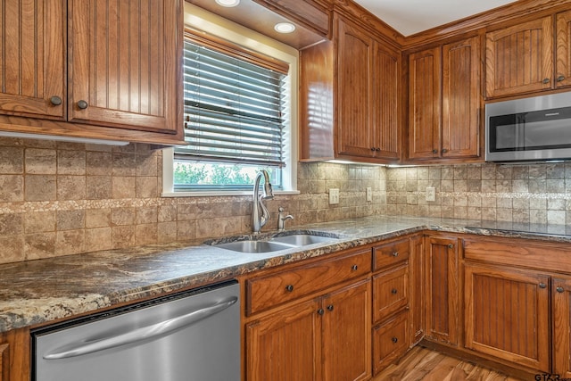 559 Elm St, Frankston, TX 75763 - kitchen with appliances with stainless steel finishes, a sink, and brown cabinets