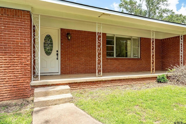 559 Elm St, Frankston, TX 75763 - view of exterior entry featuring brick siding and covered porch