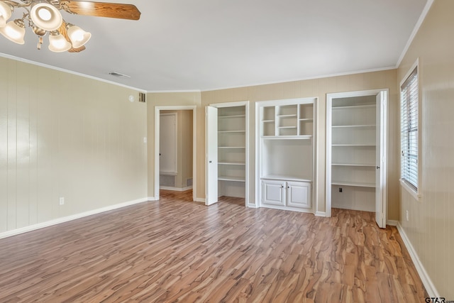 559 Elm St, Frankston, TX 75763 - unfurnished bedroom with light wood-style floors, ornamental molding, two closets, and baseboards