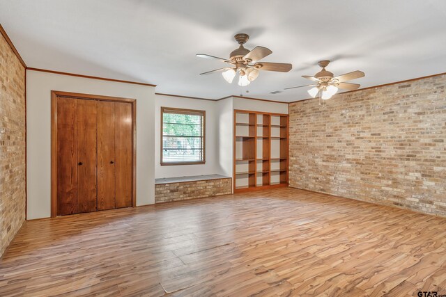 559 Elm St, Frankston, TX 75763 - unfurnished living room with wood finished floors, a ceiling fan, brick wall, and ornamental molding