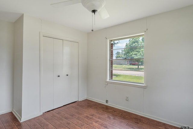 559 Elm St, Frankston, TX 75763 - unfurnished bedroom featuring wood finished floors, a closet, baseboards, and a ceiling fan