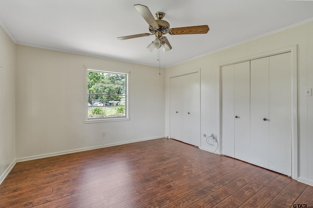 559 Elm St, Frankston, TX 75763 - unfurnished bedroom featuring wood-type flooring, crown molding, two closets, baseboards, and a ceiling fan