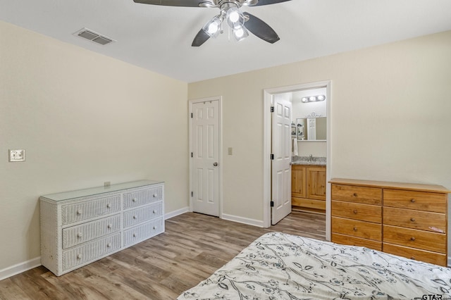 3466 County Road 4305, Larue, TX 75770 - bedroom with wood finished floors, baseboards, ensuite bath, and ceiling fan