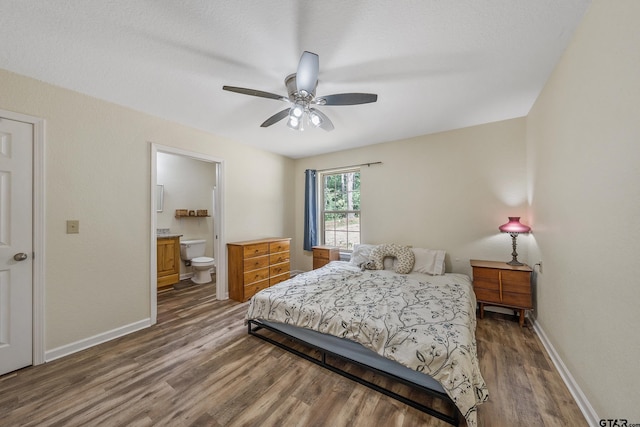 3466 County Road 4305, Larue, TX 75770 - bedroom featuring wood finished floors, baseboards, ensuite bathroom, and a ceiling fan
