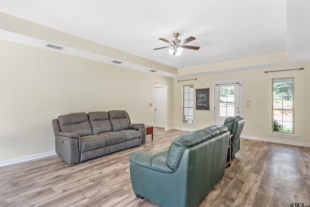 3466 County Road 4305, Larue, TX 75770 - living area featuring wood finished floors, a ceiling fan, and a raised ceiling