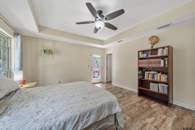 3466 County Road 4305, Larue, TX 75770 - bedroom with wood finished floors, a raised ceiling, baseboards, and ceiling fan