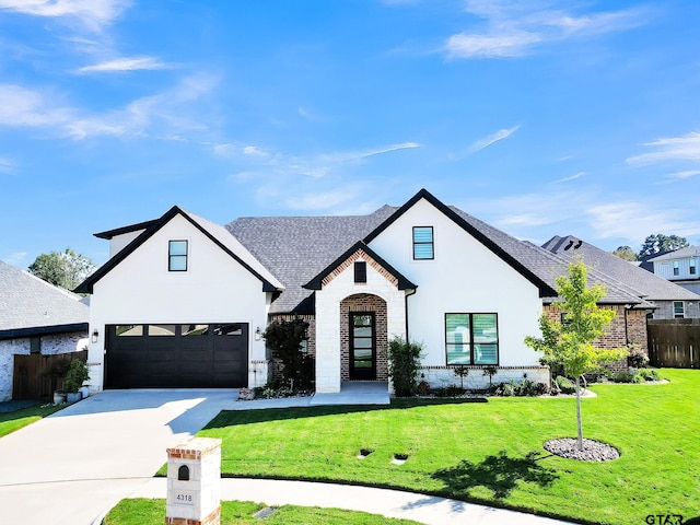 view of front of home with a garage and a front lawn