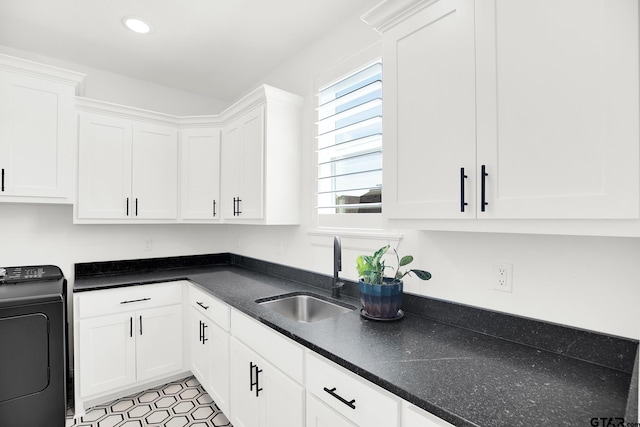 kitchen featuring white cabinetry, washer / dryer, sink, and light tile patterned floors