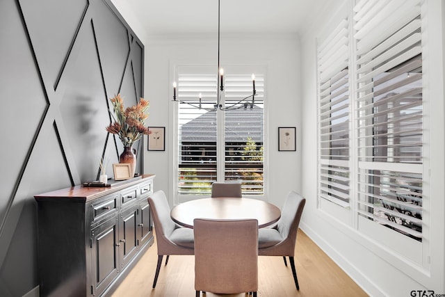 dining space featuring crown molding and light wood-type flooring