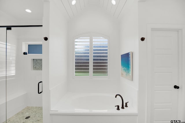 bathroom featuring vaulted ceiling and plus walk in shower