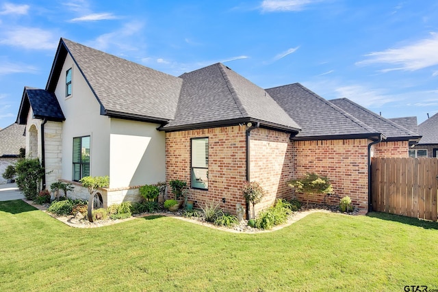 view of side of home with a lawn