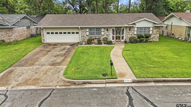 2742 Lisa Ln, Tyler, TX 75701 - ranch-style home featuring a garage, a front yard, concrete driveway, and a shingled roof