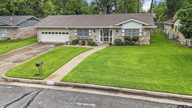 2742 Lisa Ln, Tyler, TX 75701 - ranch-style house with a garage, roof with shingles, a front lawn, and concrete driveway