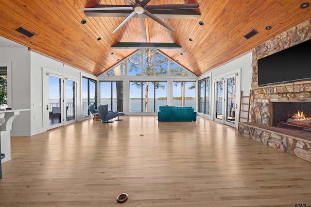 interior space with wooden ceiling, high vaulted ceiling, a fireplace, and visible vents