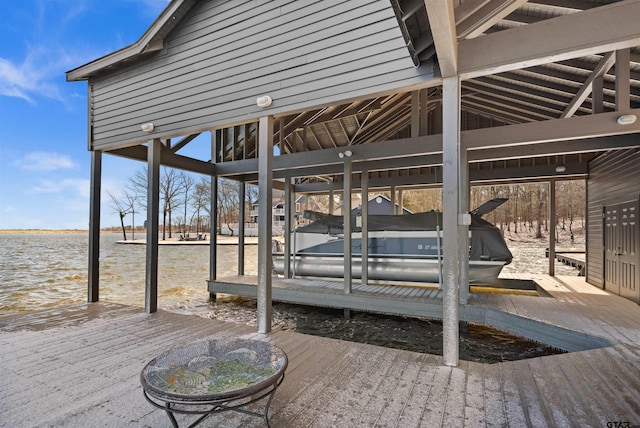 view of patio / terrace featuring a water view, boat lift, and a boat dock