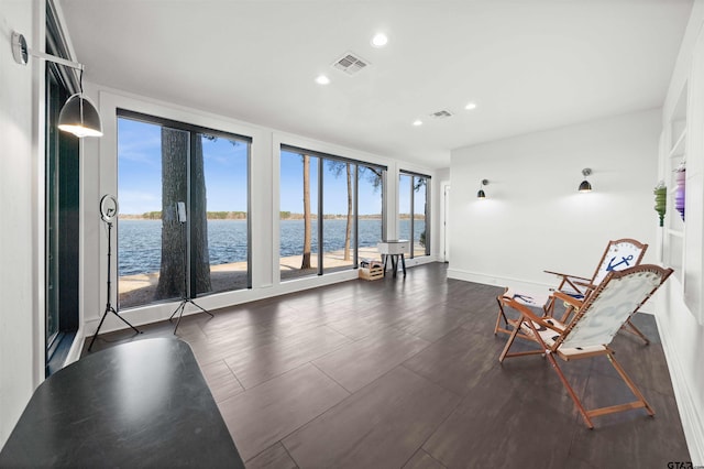 unfurnished room with baseboards, a water view, visible vents, and recessed lighting