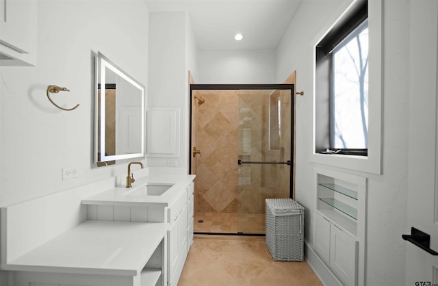 bathroom featuring plenty of natural light, a shower stall, vanity, and tile patterned floors