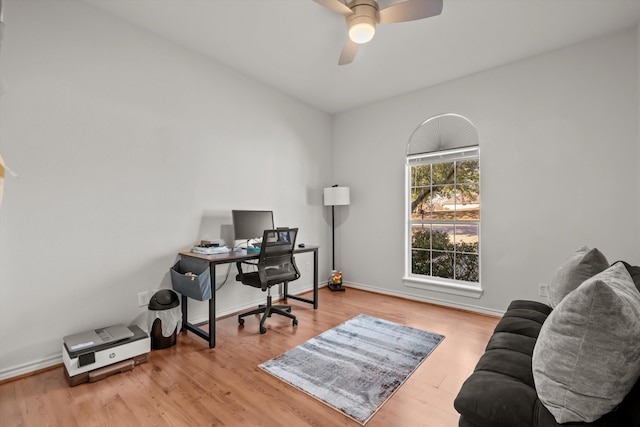 office area with baseboards, a ceiling fan, and wood finished floors