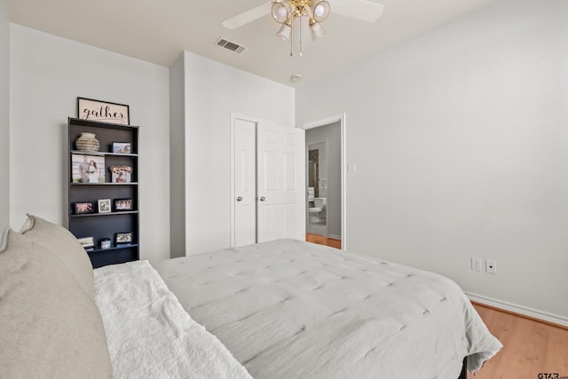 bedroom with visible vents, ceiling fan, and wood finished floors