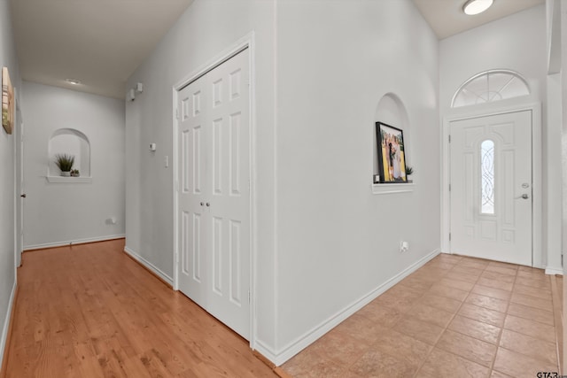 foyer featuring baseboards