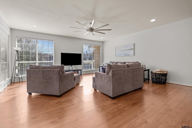 living room featuring a ceiling fan, plenty of natural light, light wood-style floors, and recessed lighting