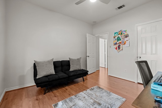 office space with visible vents, a ceiling fan, baseboards, and wood finished floors