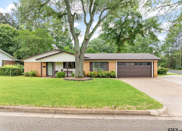 311 E Amherst St, Tyler, TX 75703 - single story home with brick siding, driveway, a garage, and a front lawn