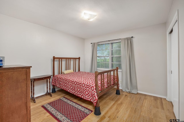 311 E Amherst St, Tyler, TX 75703 - bedroom featuring light wood-type flooring, baseboards, and a closet