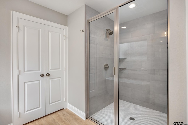 19128 Ambrosia Dr, Flint, TX 75762 - bathroom with a stall shower, wood finished floors, recessed lighting, and baseboards