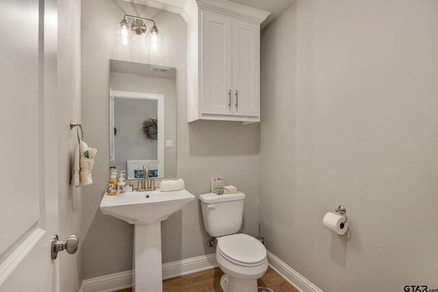 19128 Ambrosia Dr, Flint, TX 75762 - bathroom featuring toilet, wood finished floors, and baseboards