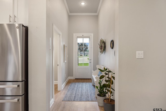 19128 Ambrosia Dr, Flint, TX 75762 - doorway to outside featuring light wood-type flooring, baseboards, and ornamental molding