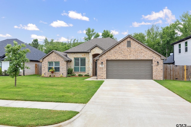 19128 Ambrosia Dr, Flint, TX 75762 - french country style house with an attached garage, concrete driveway, brick siding, and roof with shingles
