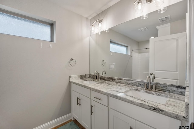 19128 Ambrosia Dr, Flint, TX 75762 - full bath featuring baseboards, double vanity, and a shower