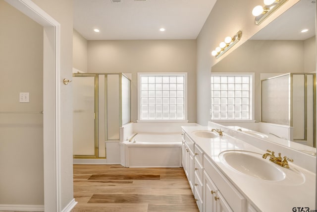 bathroom featuring vanity, hardwood / wood-style flooring, and independent shower and bath