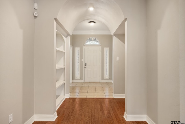 foyer featuring light hardwood / wood-style floors and ornamental molding