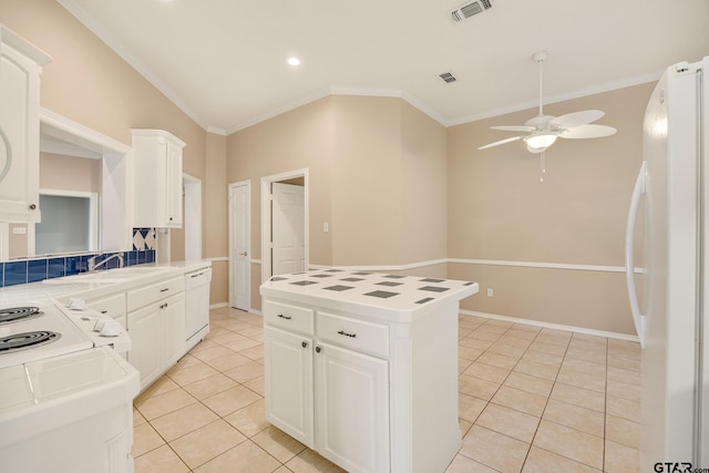 kitchen with crown molding, white cabinetry, white appliances, ceiling fan, and a center island