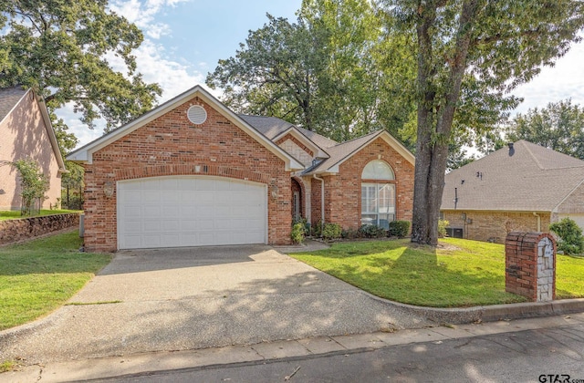 view of property with a garage and a front yard