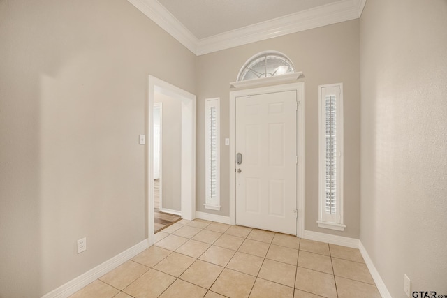 tiled foyer featuring crown molding