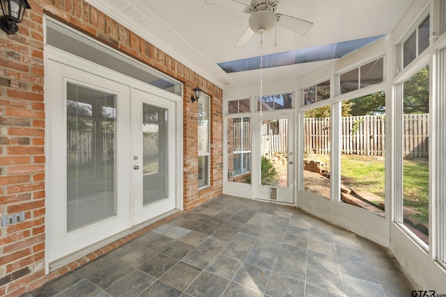 unfurnished sunroom featuring french doors and ceiling fan