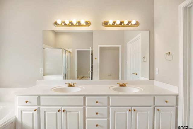 bathroom featuring independent shower and bath and vanity