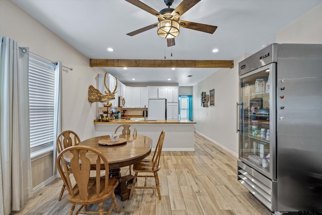 dining room featuring light wood-type flooring, plenty of natural light, and ceiling fan