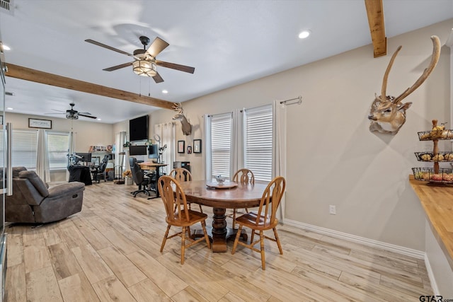 dining area with beamed ceiling, ceiling fan, light hardwood / wood-style floors, and plenty of natural light