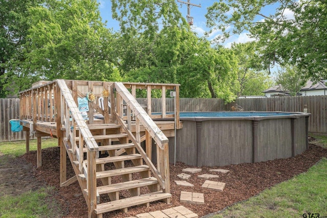 wooden deck featuring a fenced in pool