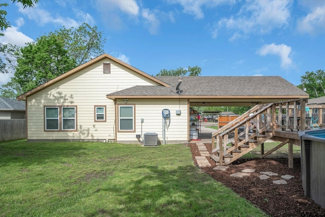 back of property featuring central air condition unit, a lawn, and a patio area