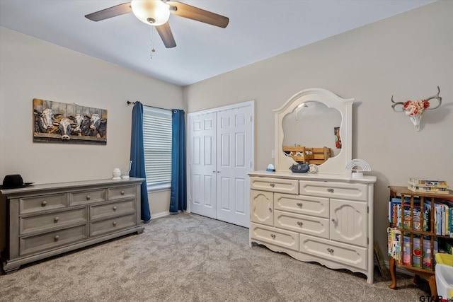 bedroom with ceiling fan, light carpet, and a closet