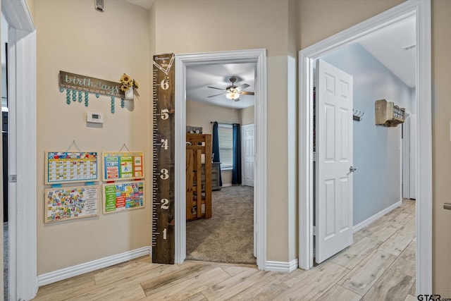 hall with light hardwood / wood-style floors