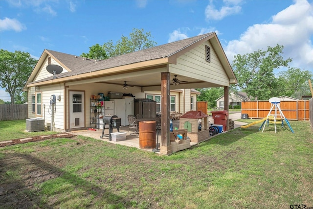 back of property featuring central AC, a patio area, a playground, a yard, and ceiling fan