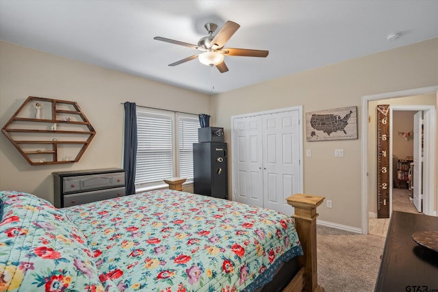 carpeted bedroom featuring ceiling fan and a closet